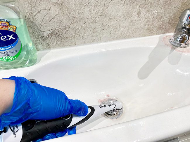 scrubbing a sink plug